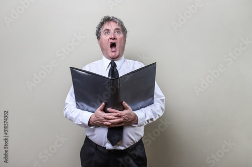 Older man singing in a choir photo