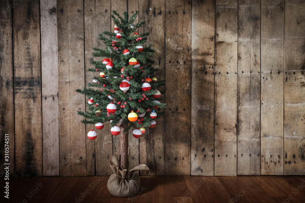 Christmas tree hung with brightly colored fishing bobber floats Stock Photo
