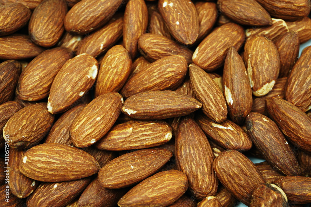 Top view brown Almond nuts close up background Top view brown Almond nuts close up background