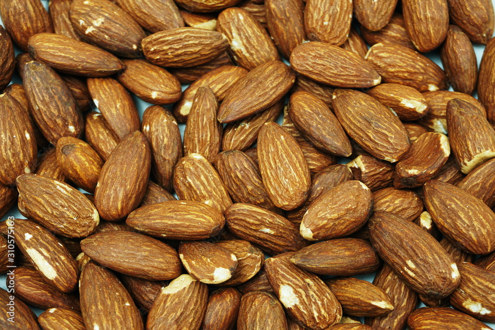 Top view brown Almond nuts close up background Top view brown Almond nuts close up background