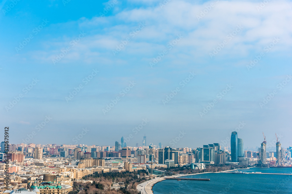 Bright panoramic cityscape view of Baku, Azerbaijan. The downtown scenic view to old city and modern with tall skyscrapers near the coast of Caspian sea.