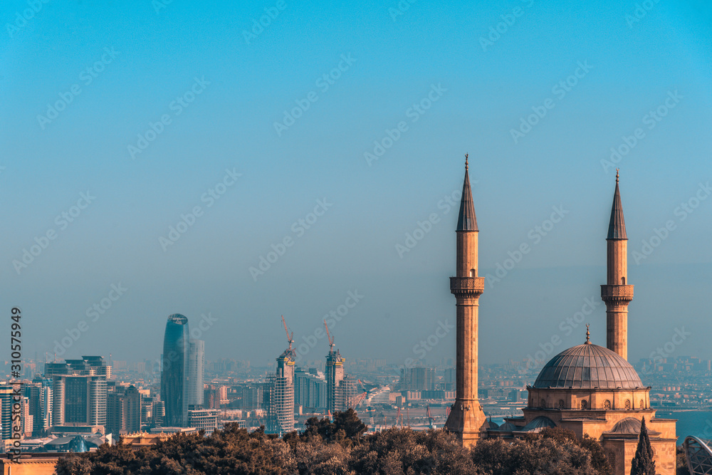 Beautiful bright panoramic cityscape view of Baku, Azerbaijan. The downtown scenic view to old city and modern with tall skyscrapers near the coast of Caspian sea. Şəhidlər Xiyabanı Məscidi mosque.