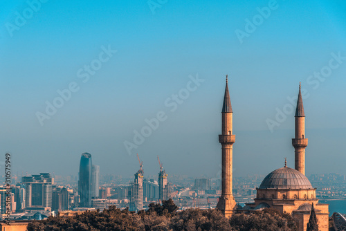 Beautiful bright panoramic cityscape view of Baku, Azerbaijan. The downtown scenic view to old city and modern with tall skyscrapers near the coast of Caspian sea. Şəhidlər Xiyabanı Məscidi mosque.