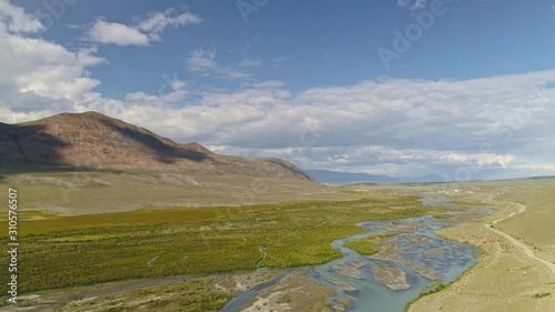 Aerial fly above river floodplain rugged with islets and edged with green shore photo