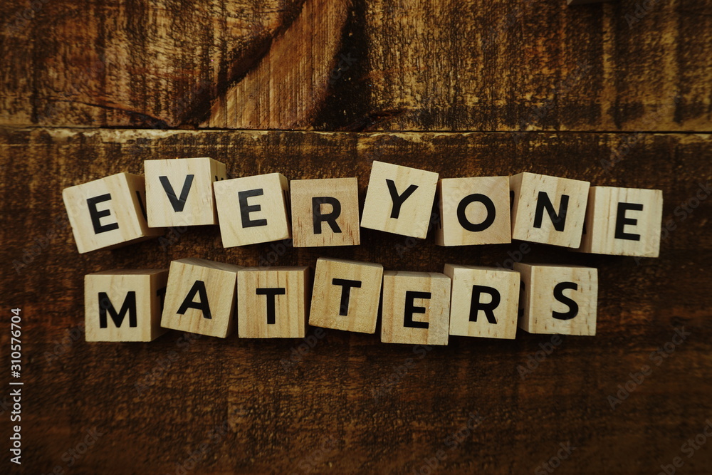 Fototapeta premium everyone matters letters on wooden background business concept for equality respect