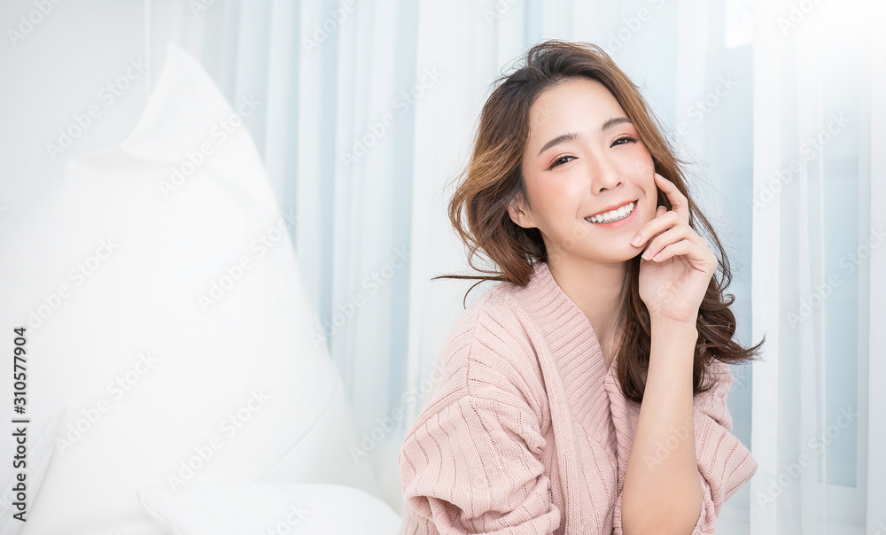 Portrait of young beautiful asian woman relax face in winter bedroom. Sexy  beauty girl with healthy makeup facial treatment perfect glow skin. Smile  happy asian korean girl isolated white background. Stock Photo