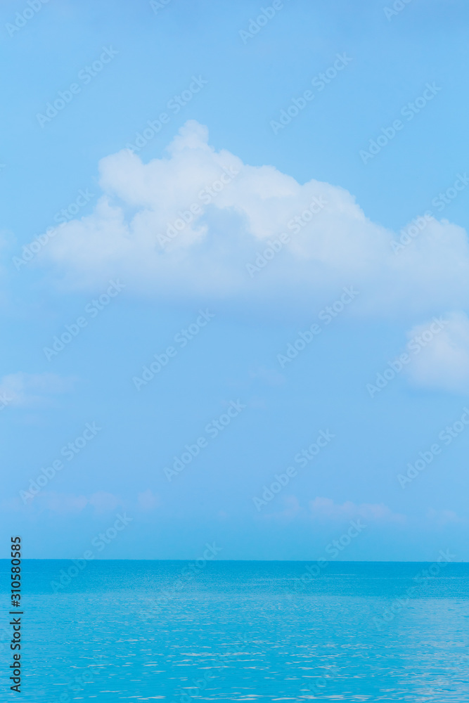 Floating clouds, fluffy colors against the blue sky and the sea