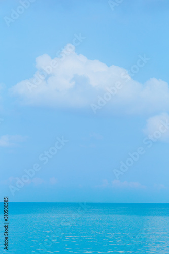 Floating clouds  fluffy colors against the blue sky and the sea