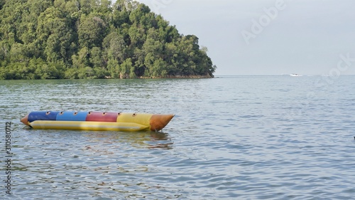 Image of seascape with hill and banana boat