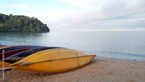 Beautiful view of colorful kayak or canoes at a beach