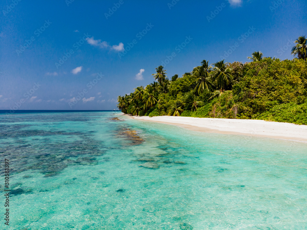 Pristine tropical beach with blue water and white sand