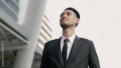 Wallpaper Mural Attractive asian businessman in black suit thinking about future business projects while standing outside on the street urban. Torontodigital.ca