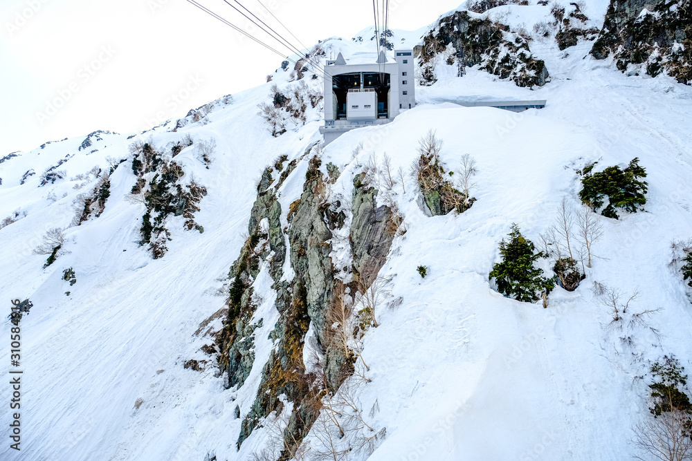 Ski Cable car travel destination, Ropeway Alpine Snow Wall Walk or airline cable rope way setting on to of mountain, transportation from and to the peak point of  Tateyama Kurobe Alpine Route, Japan. 