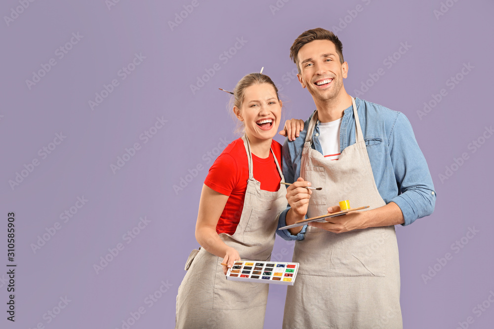 Couple of young artists on color background Couple of young artists on color background