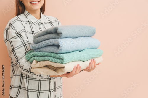 Woman with stack of winter ...