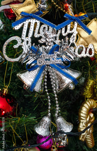 silver merry chirstmas word and Ornaments on christmas tree