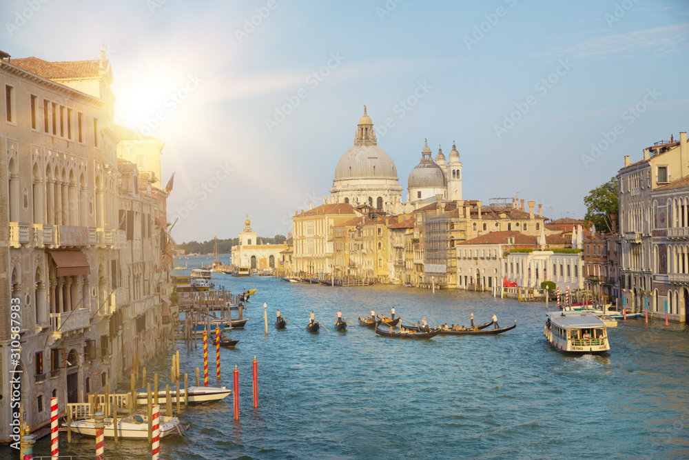 Sun flash and old cathedral of Santa Maria della Salute. The colorful venice view for historic architecture background. Venice, italy, europe.