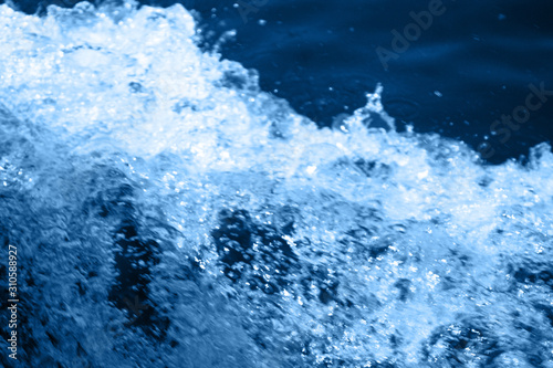 Classic blue 2020. Gradient color palette. Splashing waves on the water. Blue water background.