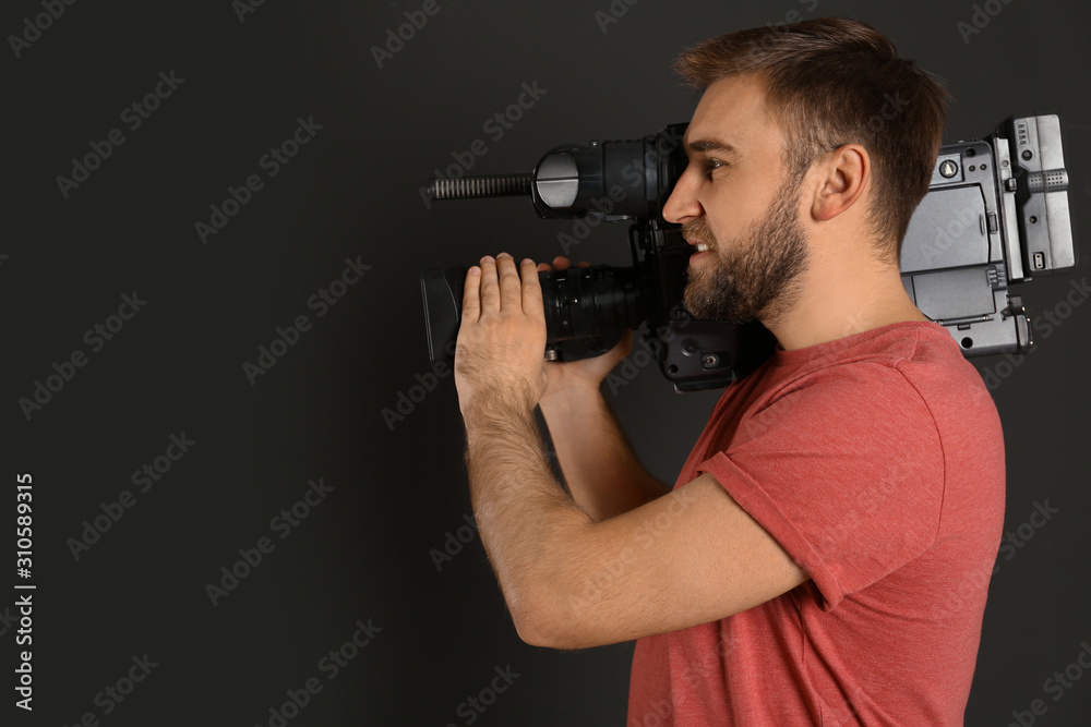 Operator with professional video camera on black background Operator with professional video camera on black background