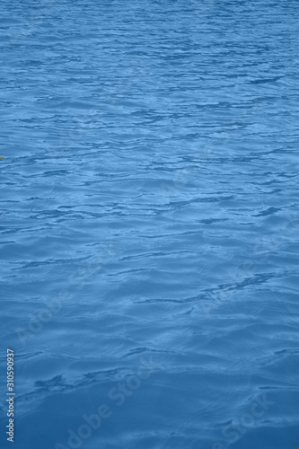 Classic blue 2020. Gradient color palette. Waves on water. Blue water background.