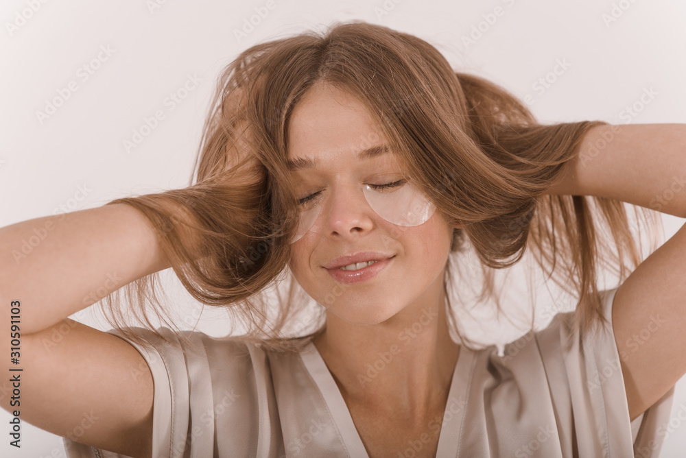Portrait of a young woman with with a eyepatch on her face.