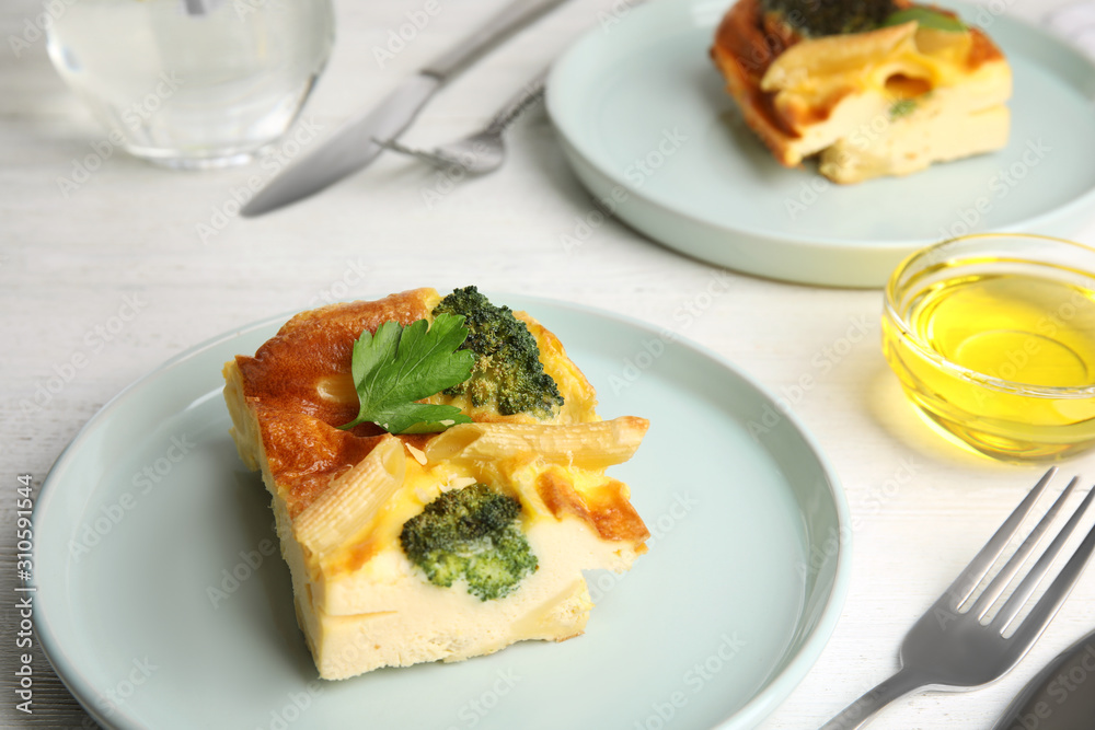 Tasty broccoli casserole served on white wooden table Tasty broccoli casserole served on white wooden table