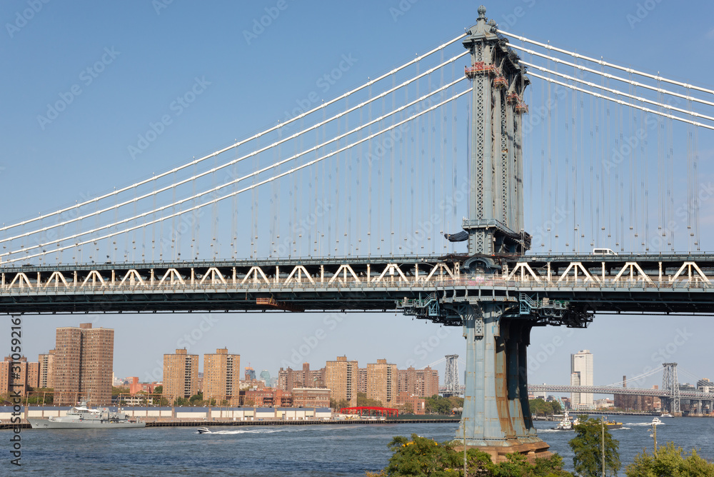Obraz premium The Manhattan Bridge tower closest to Brooklyn over the Hudson river. Taken in New York City on September the 28th, 2019