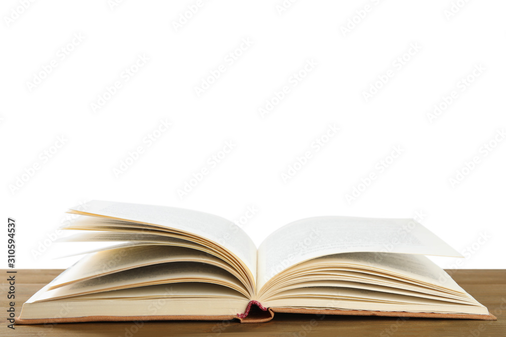 Open old hardcover book on wooden table Open old hardcover book on wooden table