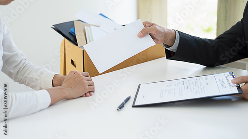 Sad dismissed businessman sitting outside the office after losing his job