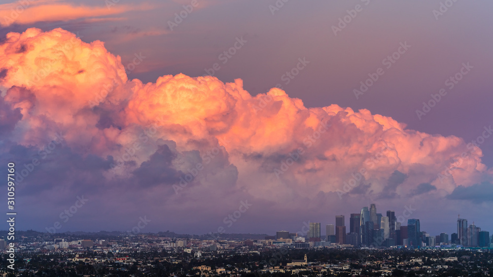 Sunset view of bright colored storm clouds approaching downtown Los Angeles, California