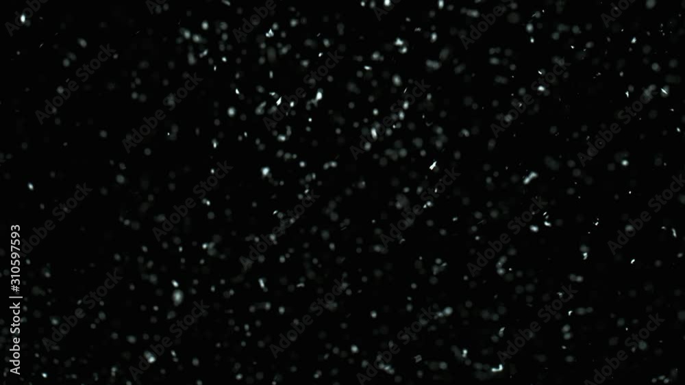 Winter Snow falling on black background in 4K. Slow Motion at 1000 fps.