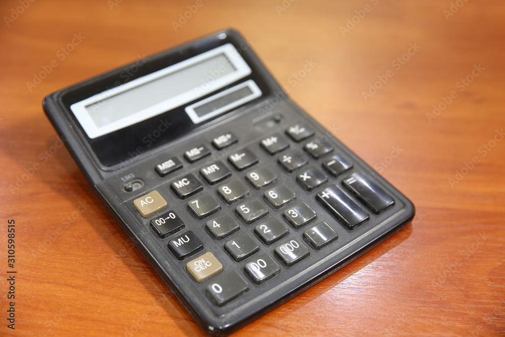 Old calculator on a wooden table. Close-up Old calculator on a wooden table. Close-up
