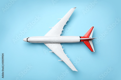 Top view of toy plane on blue background. Logistics and wholesale concept