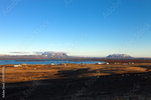 View to the small town and snowy mountains in the Iceland. Toned
