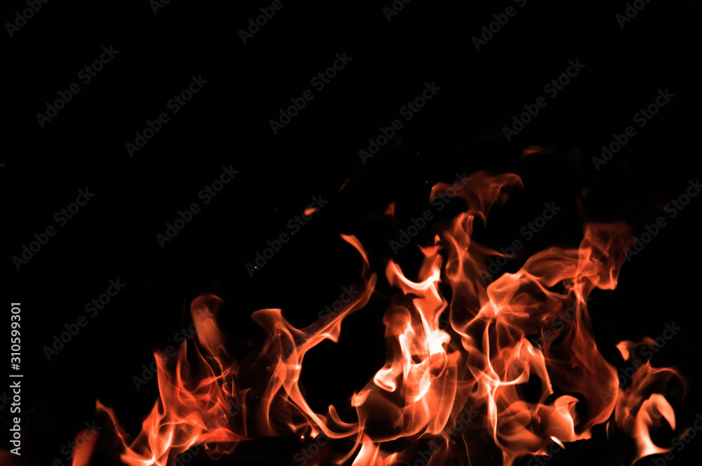 Bonfire on a black background. Fire pattern. Tongues of flame on black isolated background Bonfire on a black background. Fire pattern. Tongues of flame on black isolated background