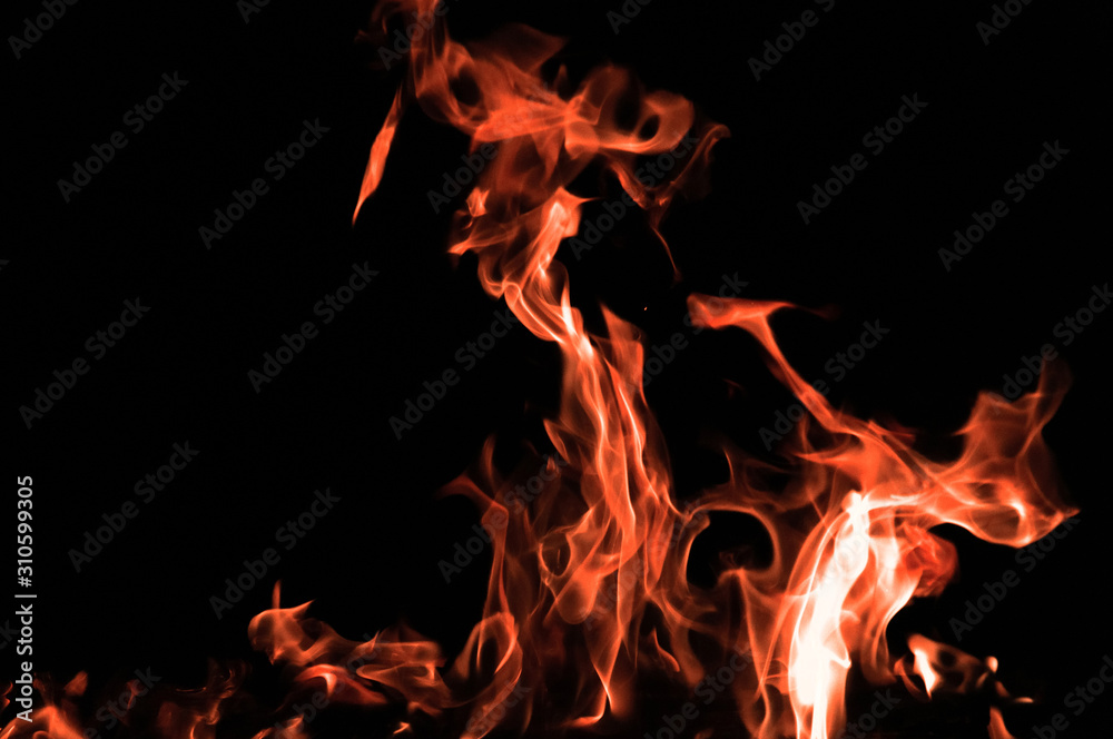 Bonfire on a black background. Fire pattern. Tongues of flame on black isolated background Bonfire on a black background. Fire pattern. Tongues of flame on black isolated background