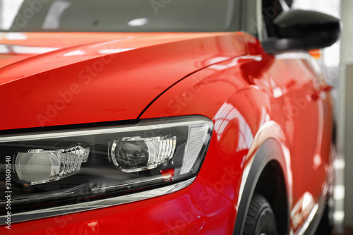 New luxury car in modern auto dealership  closeup