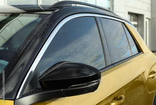 Fotografie Modern car with tinting foil on window outdoors, closeup
