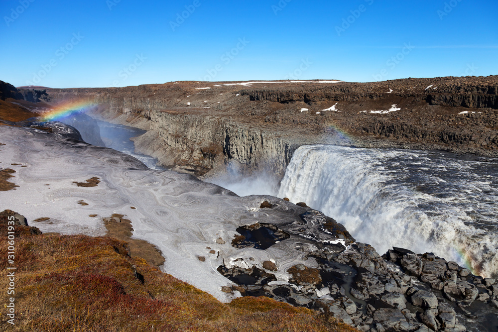 Stormy water and dirty spring snow. Beautiful view to the Dettifoss waterfall in Iceland
