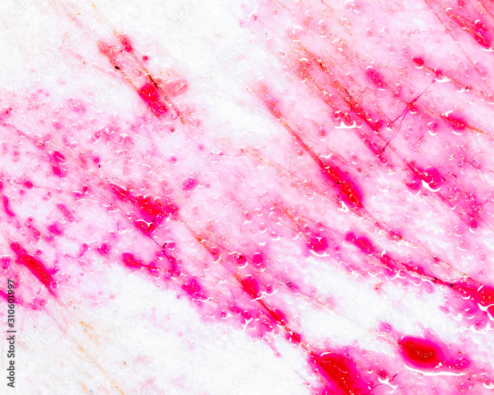 Pomegranate juice on a plastic board as an abstract background