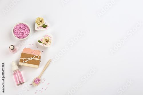 Natural handmade soap and ingredients on white background, top view