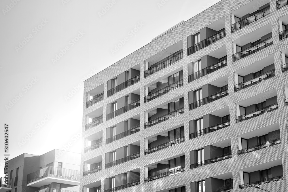 Sun rays light effects on urban buildings. Fragment of modern residential apartment with flat buildings exterior. Detail of new luxury house and home complex. Black and white. Sun rays light effects on urban buildings. Fragment of modern residential apartment with flat buildings exterior. Detail of new luxury house and home complex. Black and white.