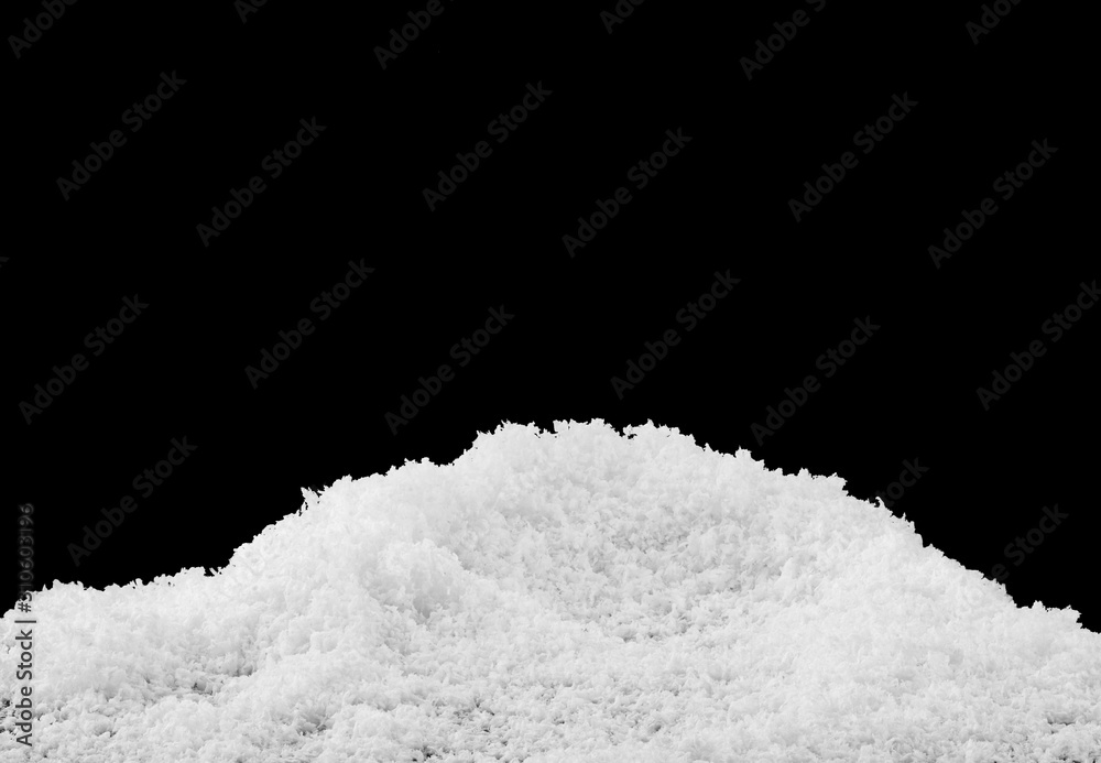 White fluffy snow isolated on a black background closeup.