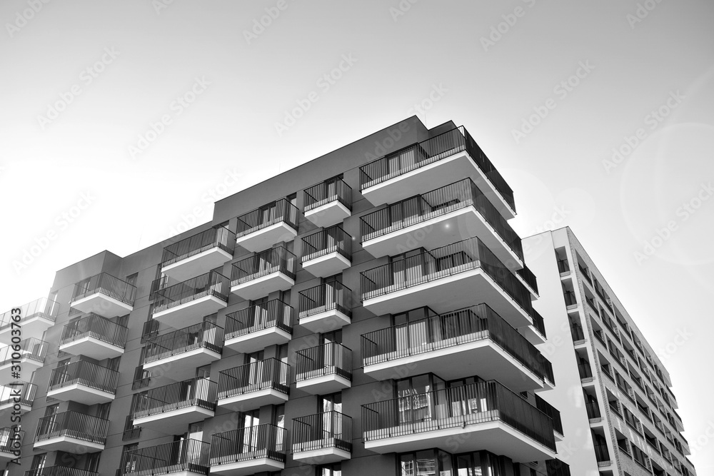 Sun rays light effects on urban buildings. Fragment of modern residential apartment with flat buildings exterior. Detail of new luxury house and home complex. Black and white. Sun rays light effects on urban buildings. Fragment of modern residential apartment with flat buildings exterior. Detail of new luxury house and home complex. Black and white.