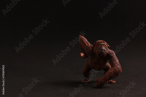 orangutan shaped plastic toy in color background © robcartorres