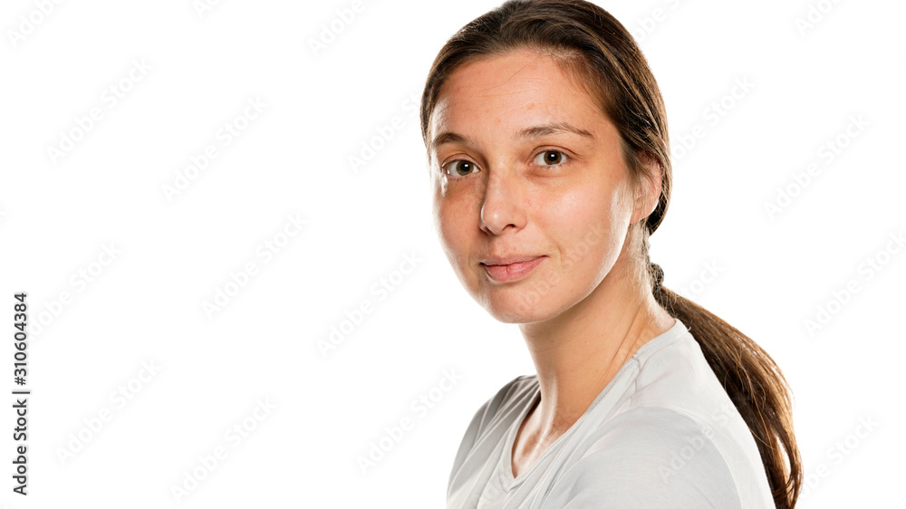 Portrait of young serious woman without makeup on white background Portrait of young serious woman without makeup on white background