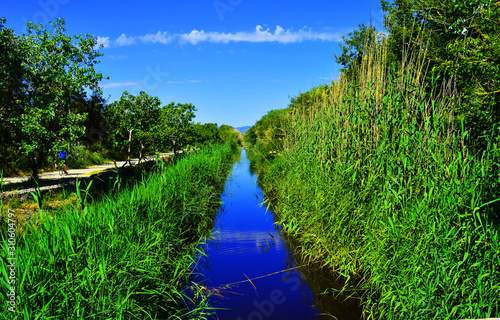 S'Albufera de Mallorca Nature Reserve in Spain . A well known landmark for birders who visit the s`Albufera nature reserve with the entrance visible on the left-hand side of the bridge.