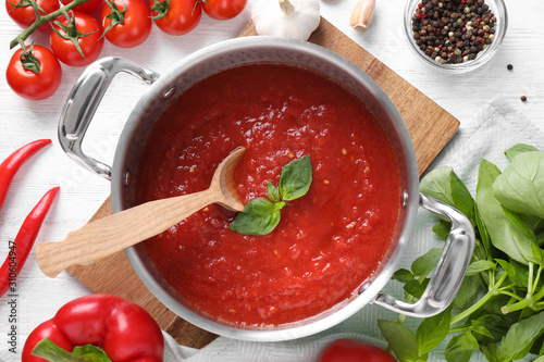 Delicious tomato sauce on white wooden table, flat lay