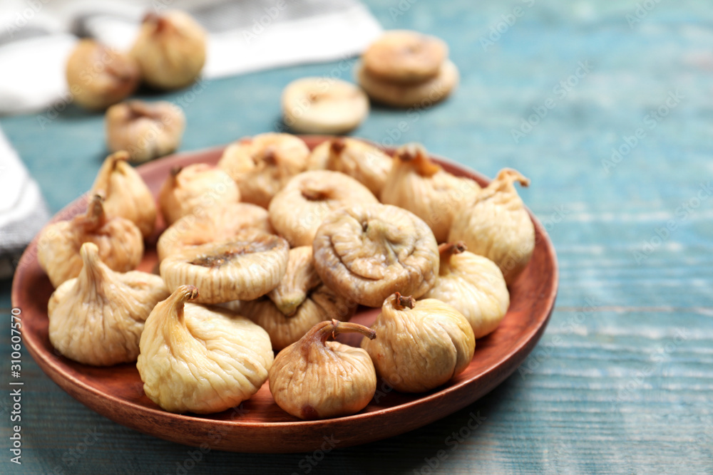 Tasty dried figs on light blue wooden table, closeup