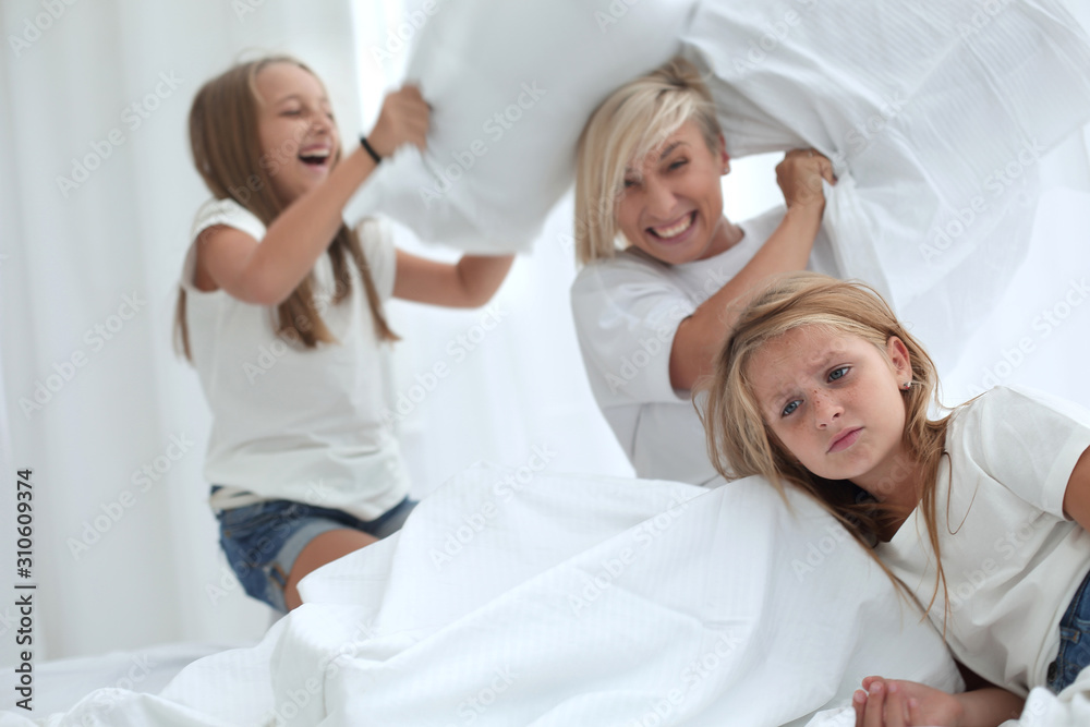 close up. fun family spends the pillow fight on the bed close up. fun family spends the pillow fight on the bed